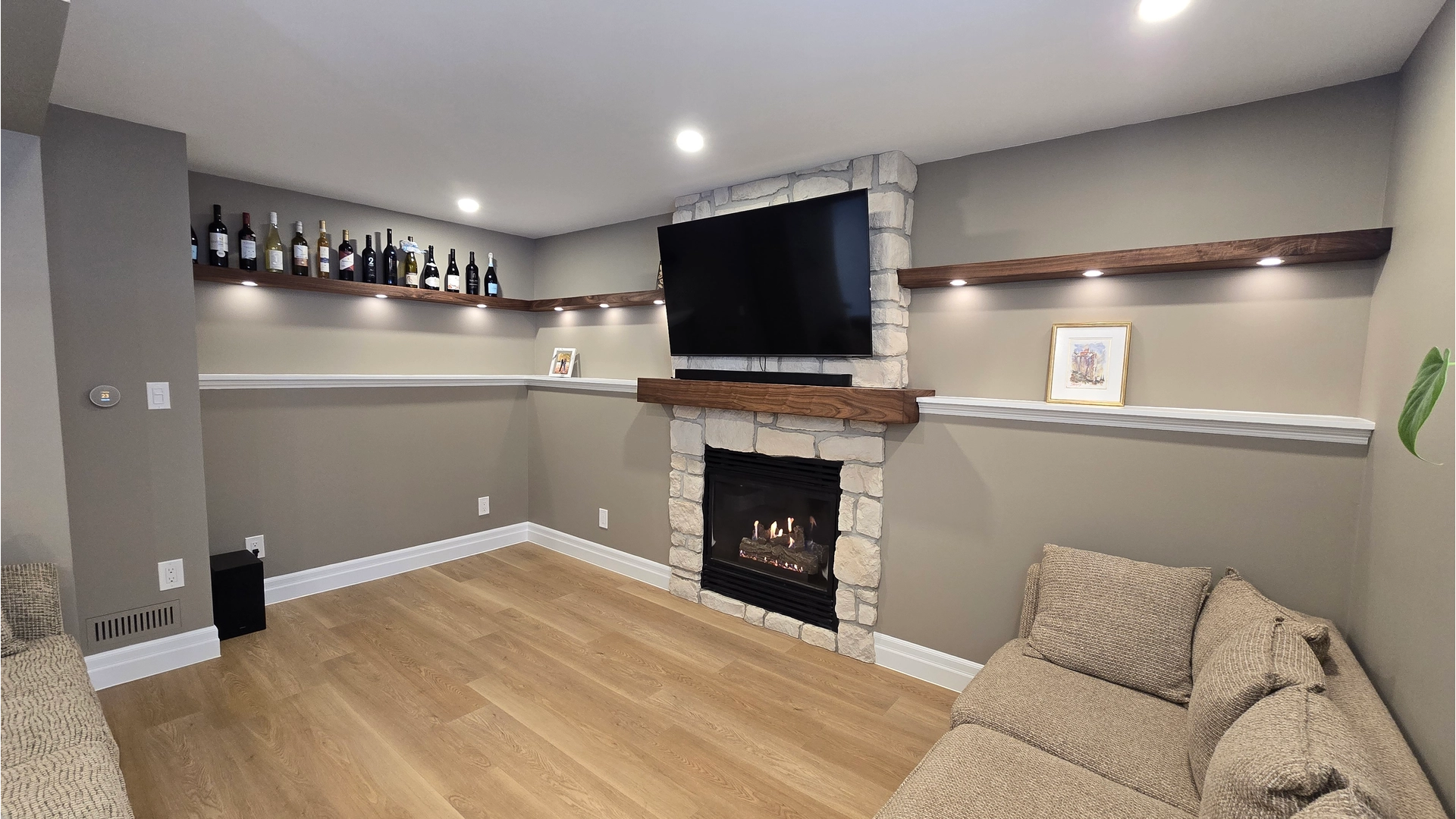 Basement renovation with fireplace and mantel